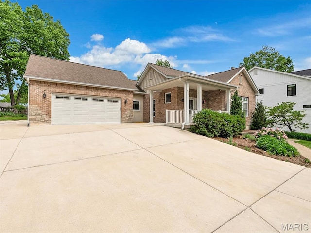602 S Ballas Rd, Saint Louis, MO 63122 - view of front facade featuring covered porch, brick siding, concrete driveway, an attached garage, and a shingled roof