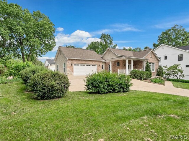602 S Ballas Rd, Saint Louis, MO 63122 - view of front of house with brick siding, concrete driveway, an attached garage, and a front lawn