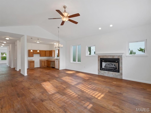 602 S Ballas Rd, Saint Louis, MO 63122 - unfurnished living room with dark wood-style flooring, vaulted ceiling, a ceiling fan, a fireplace, and a chandelier