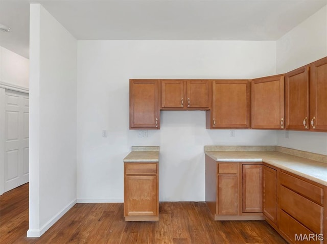602 S Ballas Rd, Saint Louis, MO 63122 - kitchen with dark wood finished floors, brown cabinets, and light countertops