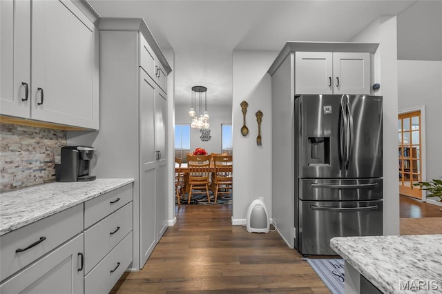 13160 Mammoth Rd, De Soto, MO 63020 - kitchen with stainless steel fridge with ice dispenser, backsplash, dark wood-style flooring, light stone counters, and a chandelier
