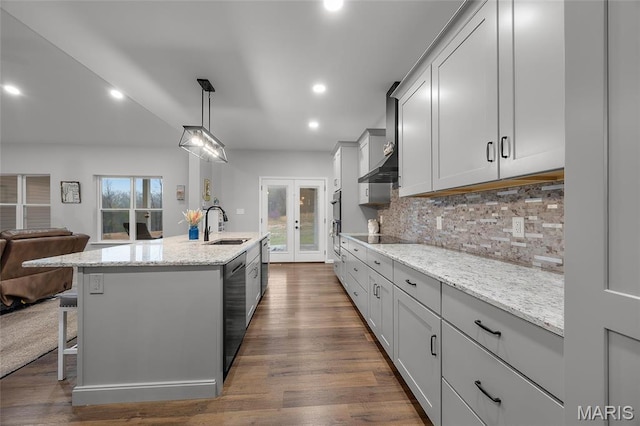 13160 Mammoth Rd, De Soto, MO 63020 - kitchen featuring decorative backsplash, light stone countertops, an island with sink, dark wood-style flooring, and recessed lighting