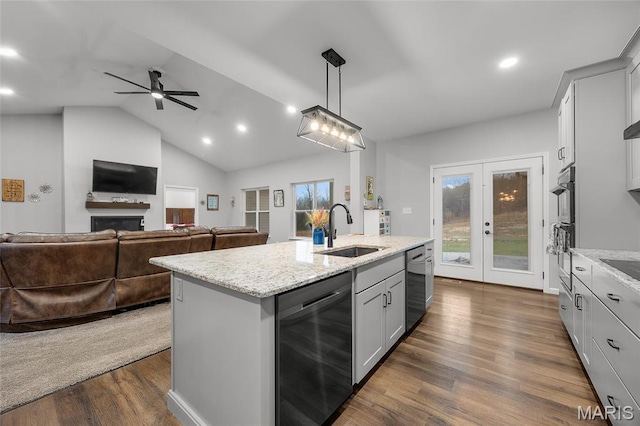 13160 Mammoth Rd, De Soto, MO 63020 - kitchen featuring stainless steel dishwasher, ceiling fan, open floor plan, light stone countertops, and vaulted ceiling
