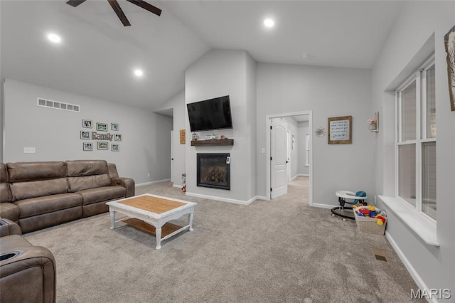 13160 Mammoth Rd, De Soto, MO 63020 - living room with a ceiling fan, carpet flooring, a glass covered fireplace, recessed lighting, and high vaulted ceiling