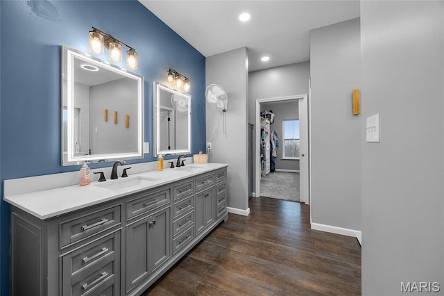 13160 Mammoth Rd, De Soto, MO 63020 - bathroom featuring double vanity, wood finished floors, and recessed lighting
