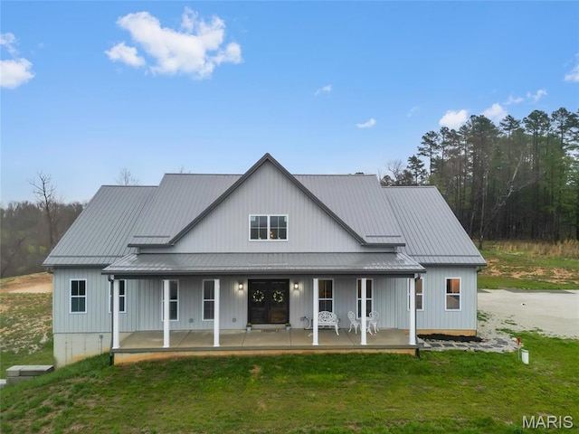 13160 Mammoth Rd, De Soto, MO 63020 - rear view of property with covered porch, a standing seam roof, a yard, and a metal roof