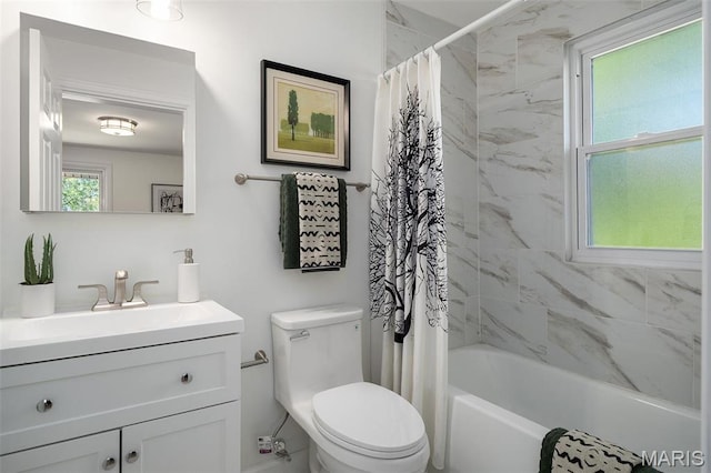 bathroom featuring toilet, vanity, and shower / tub combo with curtain