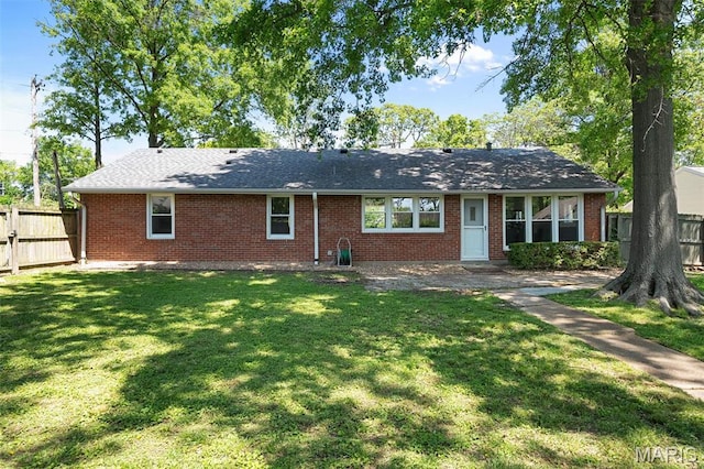 view of front of home featuring brick siding, a patio area, and a shingled roof