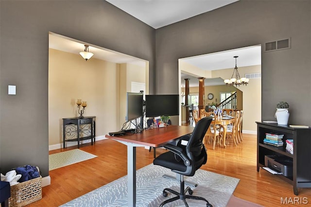 1304 Forest Way, Wentzville, MO 63385 - office space with wood finished floors, ornate columns, a chandelier, and baseboards