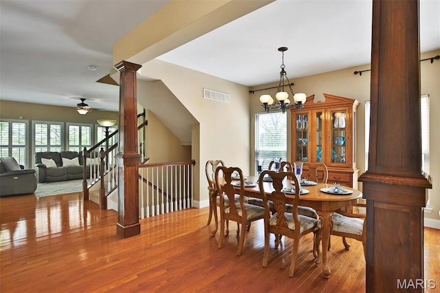 1304 Forest Way, Wentzville, MO 63385 - dining area featuring decorative columns, wood finished floors, a ceiling fan, baseboards, and a chandelier