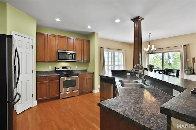 1304 Forest Way, Wentzville, MO 63385 - kitchen with appliances with stainless steel finishes, a sink, dark countertops, light wood-type flooring, and recessed lighting