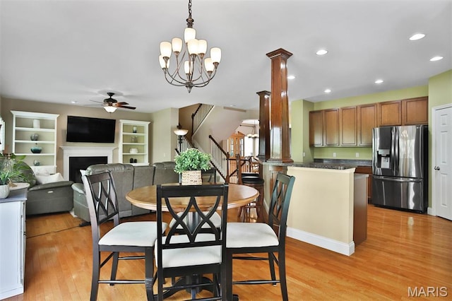 1304 Forest Way, Wentzville, MO 63385 - dining room with a ceiling fan, light wood finished floors, stairs, a fireplace, and recessed lighting