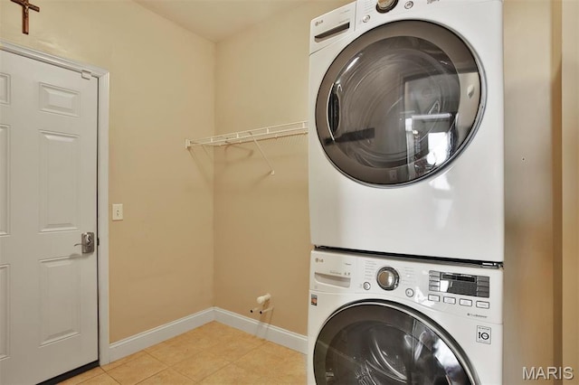 1304 Forest Way, Wentzville, MO 63385 - laundry area with stacked washer / dryer, baseboards, and light tile patterned floors