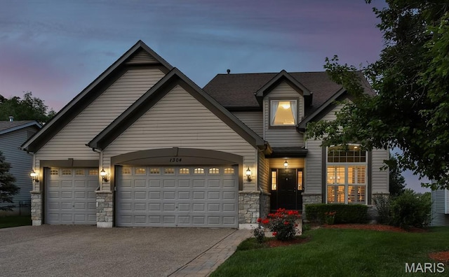 1304 Forest Way, Wentzville, MO 63385 - view of front of property with stone siding, asphalt driveway, a front yard, and an attached garage