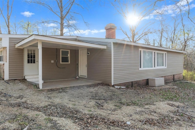 343 Del Vista Dr, Villa Ridge, MO 63089 - rear view of house featuring a chimney and a patio area