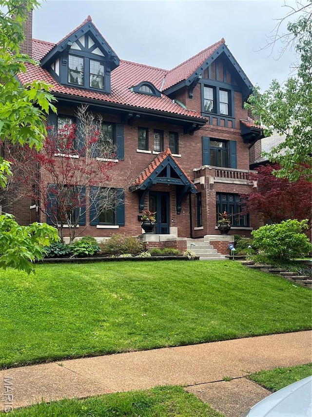 44 Kingsbury Pl, Saint Louis, MO 63112 - view of front of home with a front lawn, brick siding, and a tiled roof