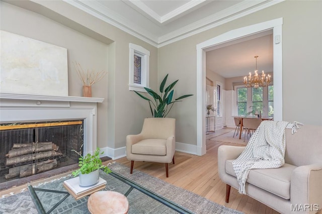 44 Kingsbury Pl, Saint Louis, MO 63112 - living room featuring a chandelier, wood finished floors, baseboards, a fireplace, and ornamental molding