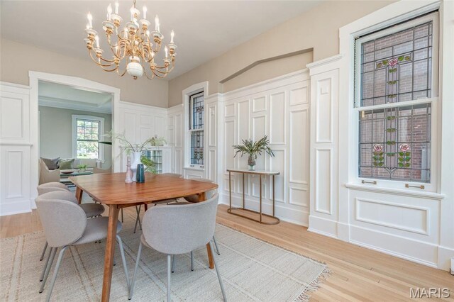 44 Kingsbury Pl, Saint Louis, MO 63112 - dining area featuring a decorative wall, a chandelier, and light wood finished floors