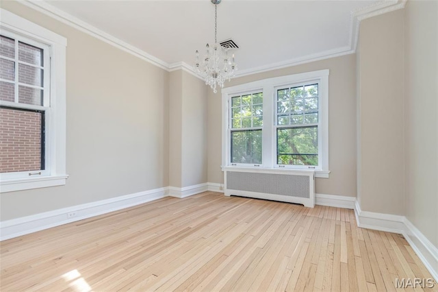 44 Kingsbury Pl, Saint Louis, MO 63112 - unfurnished room with radiator heating unit, hardwood / wood-style flooring, a chandelier, crown molding, and baseboards
