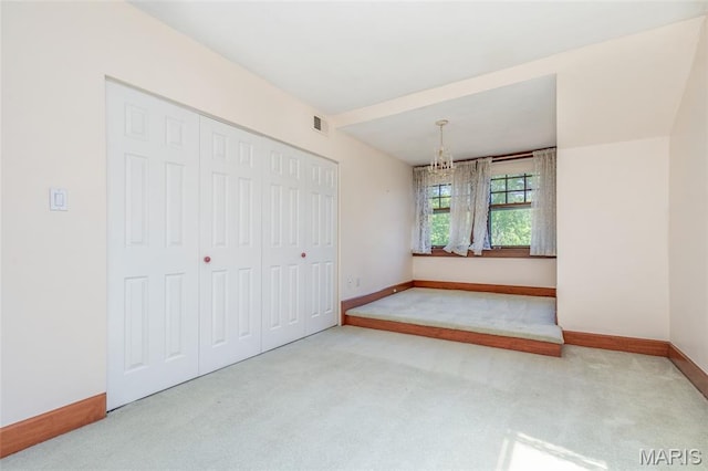 44 Kingsbury Pl, Saint Louis, MO 63112 - unfurnished bedroom with a chandelier, carpet floors, baseboards, and a closet