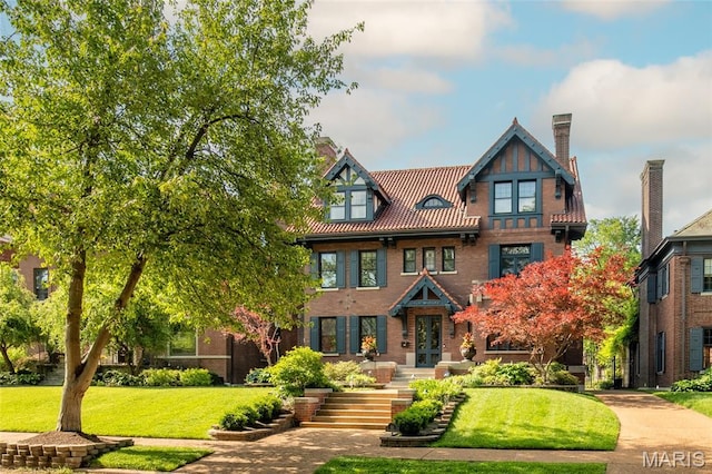 44 Kingsbury Pl, Saint Louis, MO 63112 - view of front facade featuring a chimney, a front yard, brick siding, and french doors