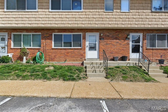 10660 Carroll Wood Way, Saint Louis, MO 63128 - entrance to property featuring uncovered parking, brick siding, and mansard roof