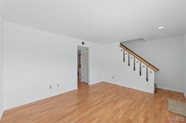 10660 Carroll Wood Way, Saint Louis, MO 63128 - unfurnished living room with light wood-style flooring, stairs, baseboards, and recessed lighting