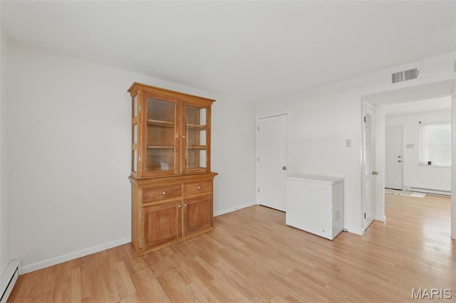 10660 Carroll Wood Way, Saint Louis, MO 63128 - spare room with light wood-style floors, a baseboard radiator, and baseboards