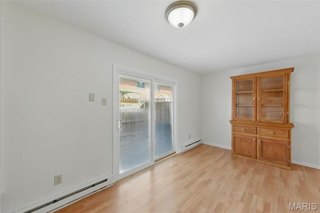 10660 Carroll Wood Way, Saint Louis, MO 63128 - spare room featuring a baseboard heating unit, light wood-style floors, and baseboards