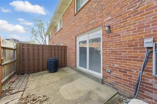 10660 Carroll Wood Way, Saint Louis, MO 63128 - view of side of home with brick siding, fence, and a patio