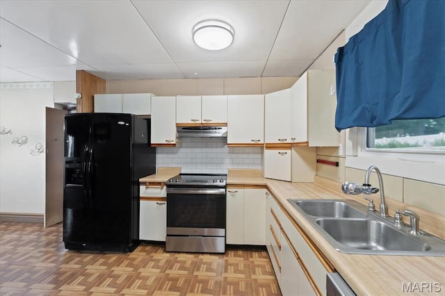 8934 Litzsinger Rd, Saint Louis, MO 63144 - kitchen with stainless steel electric stove, black fridge, a sink, under cabinet range hood, and light countertops