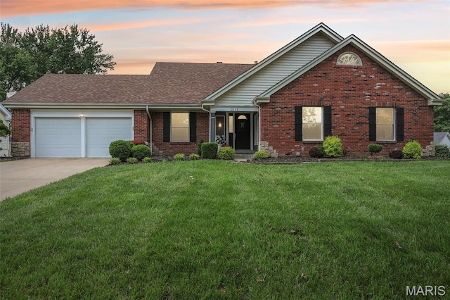 2113 Fairway Bnd, Chesterfield, MO 63017 - view of front of house featuring an attached garage, driveway, a lawn, brick siding, and a shingled roof