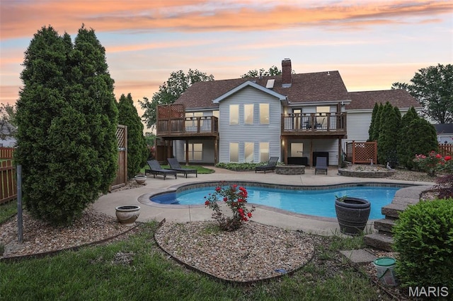 2113 Fairway Bnd, Chesterfield, MO 63017 - rear view of house with a balcony, an outdoor pool, and fence