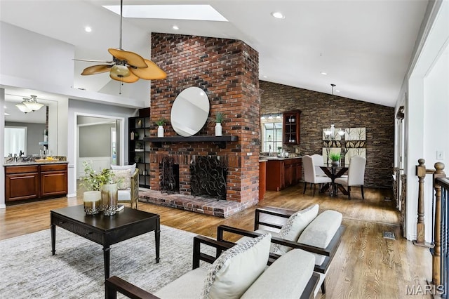 2113 Fairway Bnd, Chesterfield, MO 63017 - living room featuring light wood-type flooring, ceiling fan, high vaulted ceiling, and a fireplace
