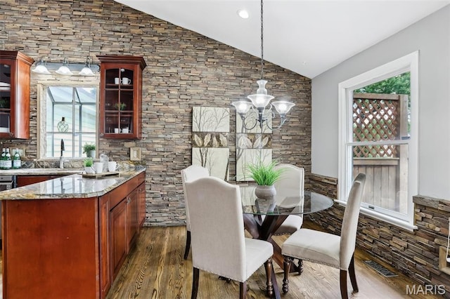 2113 Fairway Bnd, Chesterfield, MO 63017 - dining room featuring vaulted ceiling, dark wood finished floors, a chandelier, and plenty of natural light