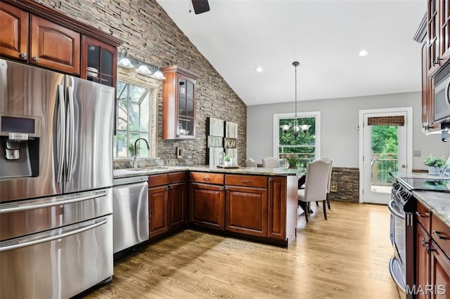 2113 Fairway Bnd, Chesterfield, MO 63017 - kitchen with stainless steel appliances, a sink, light wood-type flooring, glass insert cabinets, and recessed lighting