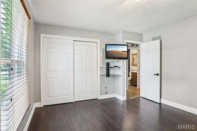 2113 Fairway Bnd, Chesterfield, MO 63017 - unfurnished bedroom featuring dark wood-style floors, baseboards, and a closet