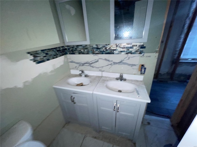 2242 Osage St, Saint Louis, MO 63118 - bathroom with double vanity, toilet, backsplash, and tile patterned floors