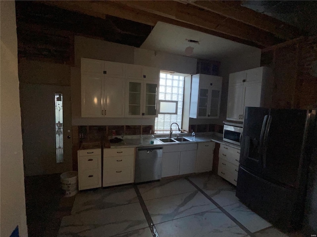 2242 Osage St, Saint Louis, MO 63118 - kitchen featuring stainless steel appliances, a sink, light marble finish floors, white cabinetry, and glass insert cabinets