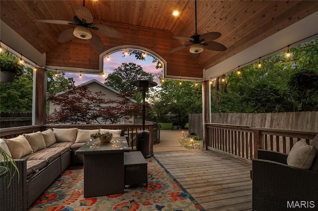 2521 High School Dr, Saint Louis, MO 63144 - deck at dusk with ceiling fan, an outdoor hangout area, and a fenced backyard