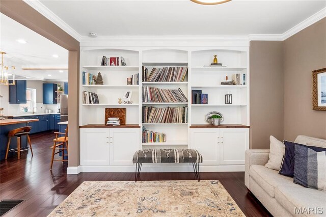 2521 High School Dr, Saint Louis, MO 63144 - sitting room featuring dark wood-type flooring, ornamental molding, built in shelves, and recessed lighting