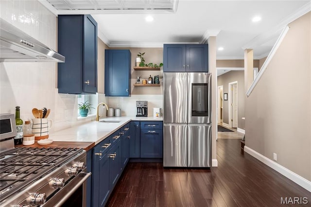 2521 High School Dr, Saint Louis, MO 63144 - kitchen with stainless steel appliances, blue cabinets, a sink, wall chimney exhaust hood, and recessed lighting