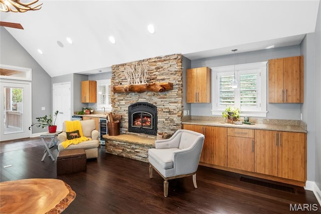 2521 High School Dr, Saint Louis, MO 63144 - living room featuring dark wood finished floors, a fireplace, high vaulted ceiling, recessed lighting, and baseboards