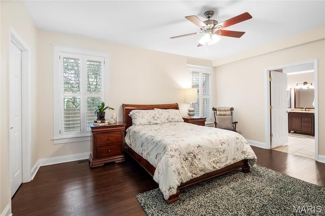 2521 High School Dr, Saint Louis, MO 63144 - bedroom featuring dark wood-style floors, baseboards, a sink, a ceiling fan, and connected bathroom