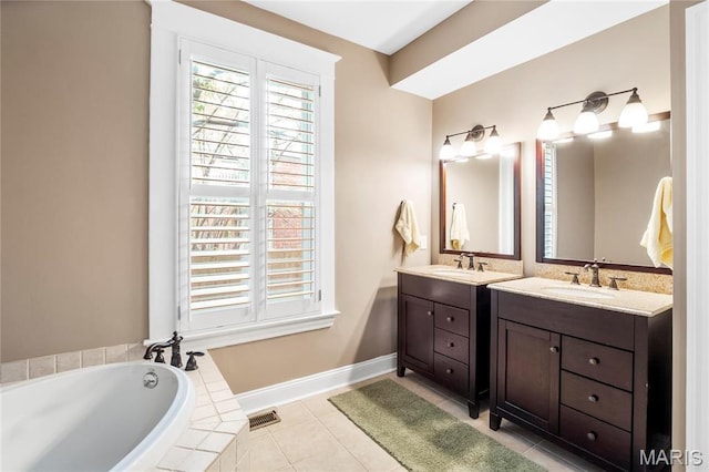 2521 High School Dr, Saint Louis, MO 63144 - bathroom featuring vanity, a bath, tile patterned floors, and baseboards