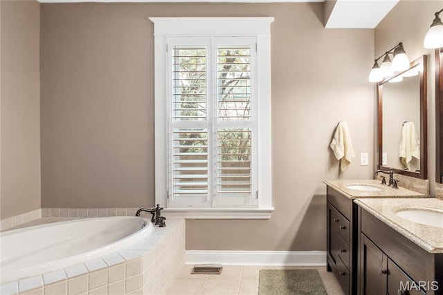 2521 High School Dr, Saint Louis, MO 63144 - full bath featuring a garden tub, tile patterned floors, double vanity, and baseboards