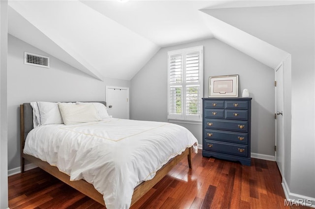 2521 High School Dr, Saint Louis, MO 63144 - bedroom with lofted ceiling, dark wood-type flooring, and baseboards