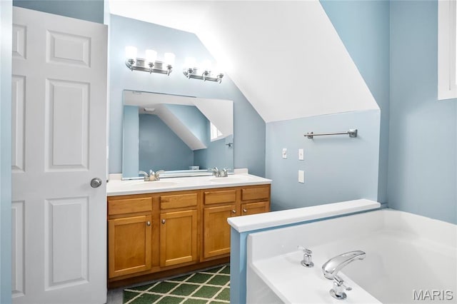 2521 High School Dr, Saint Louis, MO 63144 - bathroom with a garden tub, double vanity, and vaulted ceiling