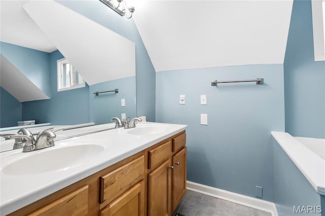 2521 High School Dr, Saint Louis, MO 63144 - bathroom with double vanity, vaulted ceiling, baseboards, and tile patterned flooring