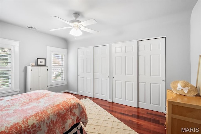 2521 High School Dr, Saint Louis, MO 63144 - bedroom with two closets, wood finished floors, ceiling fan, and baseboards